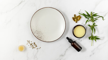 Spa marble background with CBD oil bottle, cannabis healing balm salve, capsules, plant, hemp seeds...
