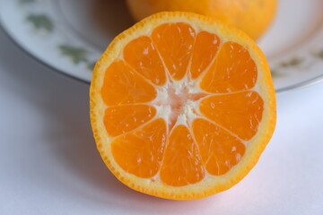 ripe and juicy tangerine (mandarin). cutaway tangerine fruit on a white background.