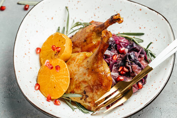 baked roasted duck goose with red cabbage and orange served on table. top view