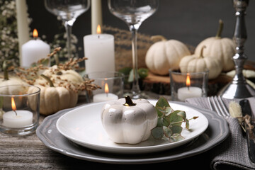 Beautiful autumn place setting and decor on wooden table