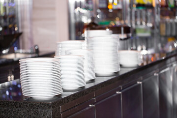 Plates A set of dishes on the table in the restaurant. Buffet. Clean dishes in the hotel kitchen. dishwasher