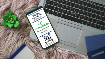 Valid digital COVID certificate on mobile device for verification. Green pass certificate for coronavirus vaccinations. Passport app in mobile phone. Coronavirus QR code scanning application.