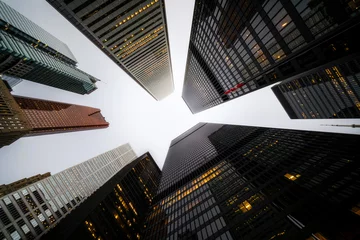 Poster Business and finance concept, looking up at modern skyscrapers at dusk in the financial district of Toronto, Ontario, Canada. © R.M. Nunes