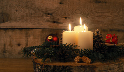 Third Advent candle burning, traditional Christmas decoration