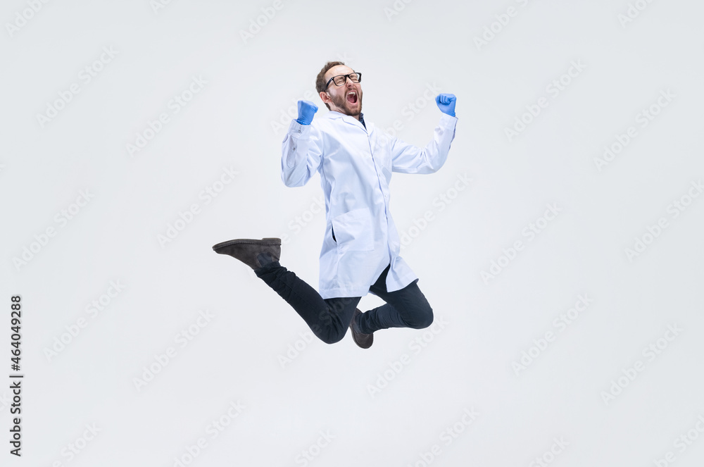 Wall mural one excited man, chemist, doctor jumping high and joy isolated on white background.