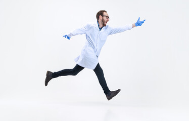 Portrait of running man, chemist, doctor in action and motion isolated on white background. Concept...