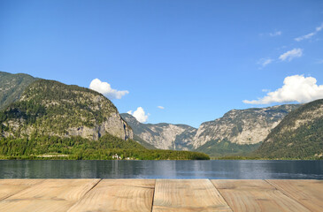 Beautiful view of mountains and wooden pier near lake on sunny day