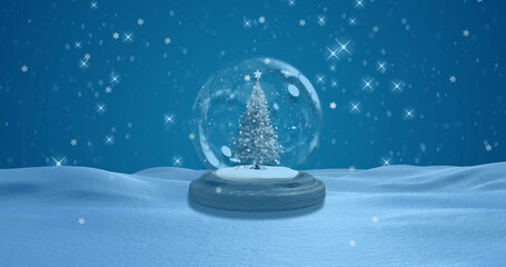 Fototapeta na wymiar Image of snow globe with christmas tree and snow falling