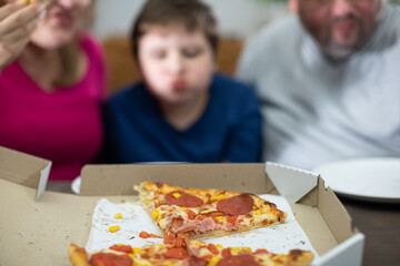 The family has eaten a delicious pizza to their heart's content and now they will be able to go on vacation.