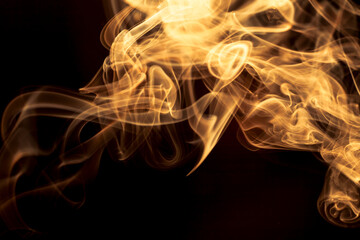 Gold smoke on black background.