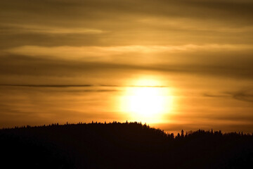Sun disc in the clouds at sunset