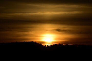 Fototapeta na wymiar Sun disc in the clouds at sunset