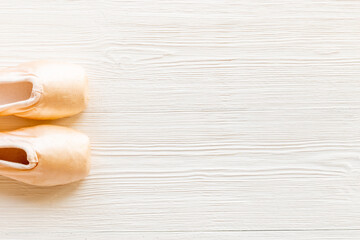 Pastel beige ballet pointe shoes or slippers with ribbon