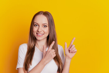 Portrait of positive cheerful girl promoter point index finger copyspace indicate advertisement isolated over shine color background