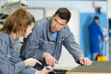 mechanic asking question to his colleague
