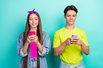 Photo of cute retro millennial couple look telephone wear pink yellow t-shirts hairband isolated on turquoise color background