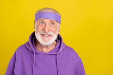Photo of cheerful aged man wondered look empty space hmm creative isolated over yellow color background