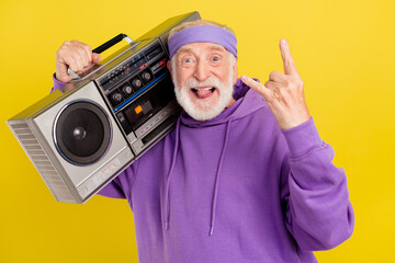 Photo of excited senior man stick-out rocker music horns symbol harsh metal party isolated over...