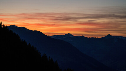 beautiful orange sunset on the mountains with view of the alps