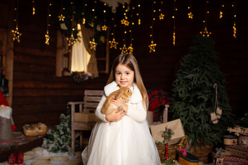 A little girl plays with her bunny friend on a fabulous Christmas night