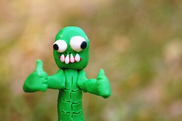 Happy zombie with two fingers raised up. The 