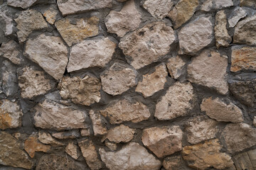 Old brick wall, old texture of red stone blocks closeup