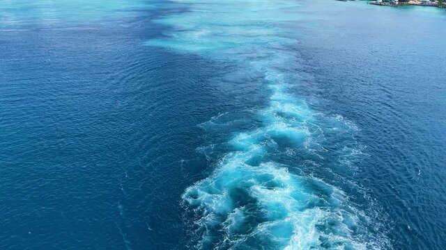A Cruise ship wake on a beautiful turquoise and blue seas