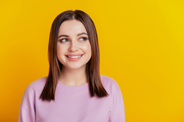 Fototapeta premium Photo of young lovely lady curious dream wonderred look empty space isolated over yellow color background