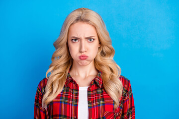 Photo of sad blond hairdo millennial lady do grimace wear plaid shirt isolated on blue color...