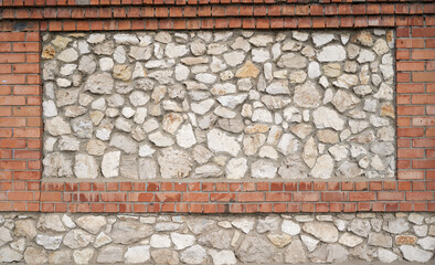 Old brick wall, old texture of red stone blocks closeup