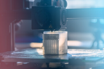 The 3D printer prints white transparent plastic model