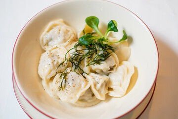 Dumplings with pepper and herbs close-up.