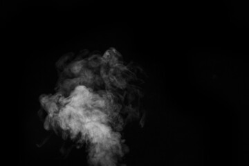 White hot curly steam smoke isolated on black background, close-up. Create mystical Halloween photos. Abstract background, design element