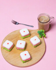 Putu Ayu cake is in the form of a box with three colors, namely green, red and white. This cake has a soft and tender texture. Putu Ayu can be found in markets or shops. Market snacks. Focus blur.
