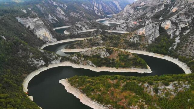 Aerial view meanders of river Uvac. Flying over the beautiful river and mountain, sunny day. Aerial drone shot, landscape panorama. River and lake Uvac in Serbia