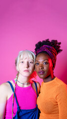 Isolated caucasian and black woman posing together for inclusion and tolerance