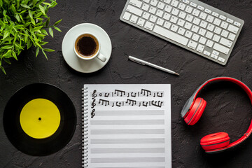 Music education with music sheets and headphones, top view