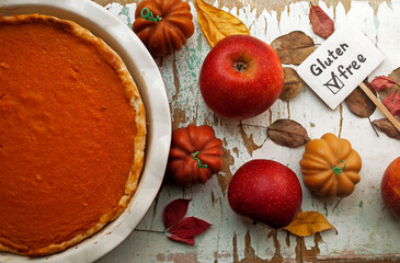 Pumpkin pie, a pie made for Thanksgiving in a baking dish. Photo of gluten free pumpkin pie. Autumn decor. Traditional Thanksgiving food. 