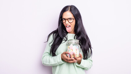 pretty hispanic woman feeling disgusted and irritated and tongue out jelly candies concept