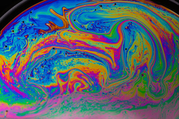 soap bubble. Close-up. Black background. Bright colors. Side view. A high resolution. Imitation of an unknown planet. Children's entertainment. Science fiction.