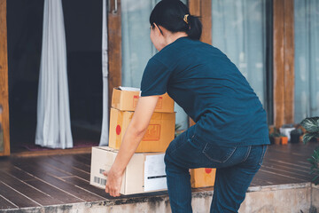 Woman with backache while lifting box.