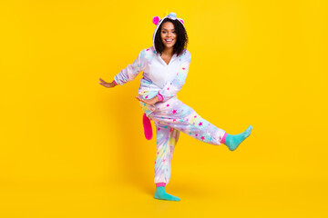 Full length body size view of pretty cheerful girl wearing funny pajama dancing isolated over bright yellow color background - obrazy, fototapety, plakaty