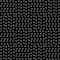Small white things on a black background. The white ripples repeat like a pattern.