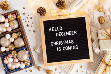 Felt letter board with text hello december, Christmas is coming and xmas decoration. Winter holidays celebration concept. Flat lay, top view