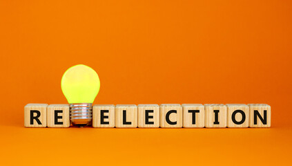 Election or reelection symbol. Cubes with words 'Election reelection'. Yellow light bulb. Beautiful orange background. Business, politic, election or reelection concept. Copy space.