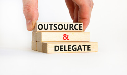 Outsource and delegate symbol. Concept words 'Outsource and delegate'. Businessman hand. Beautiful...