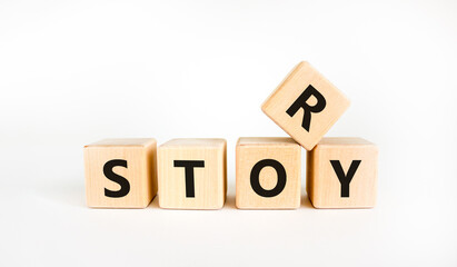 Story and storytelling symbol. The concept word 'story' on wooden cubes. Beautiful white table, white background. Business story and storytelling concept. Copy space.