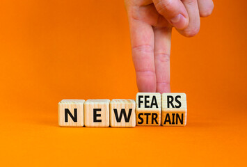 Mutated covid-19 strain virus symbol. Doctor turns cubes and changes words new strain to new fears....