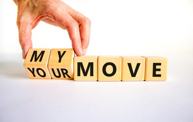 My or your move symbol. Businessman turns wooden cubes and changes words 'your move' to 'my move'. Beautiful white table, white background. My or your move and business concept. Copy space.
