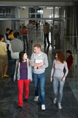 Obraz na płótnie Canvas High angle view of university students walking in hallway